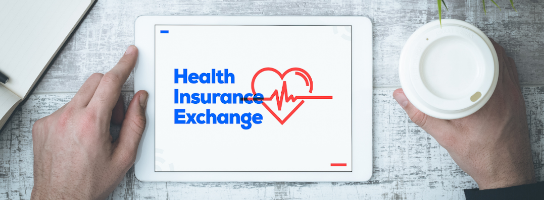 Hands next to tablet showing the text, "Health Insurance Exchange"