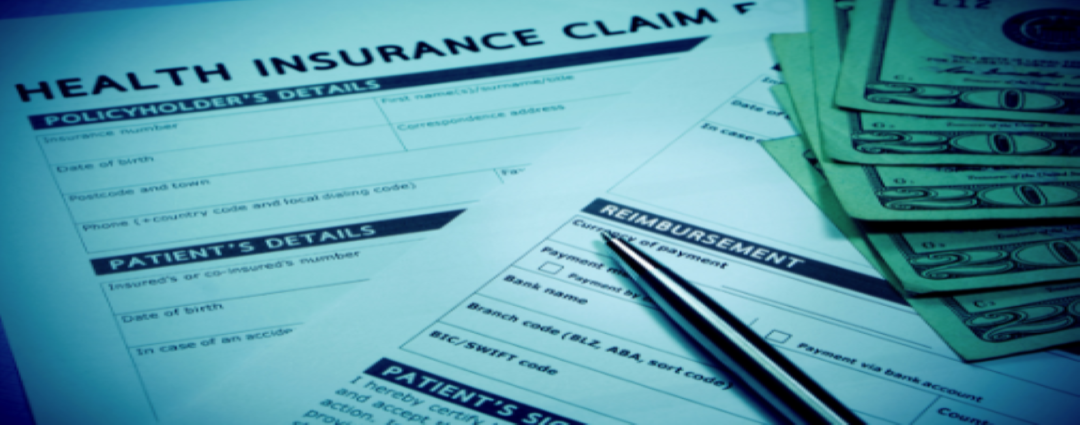 health insurance claim form with money and a pen