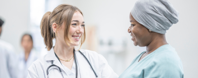 doctor smiling and talking with patient who has cancer