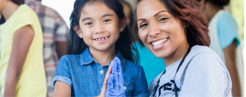 community health worker high fiving a child