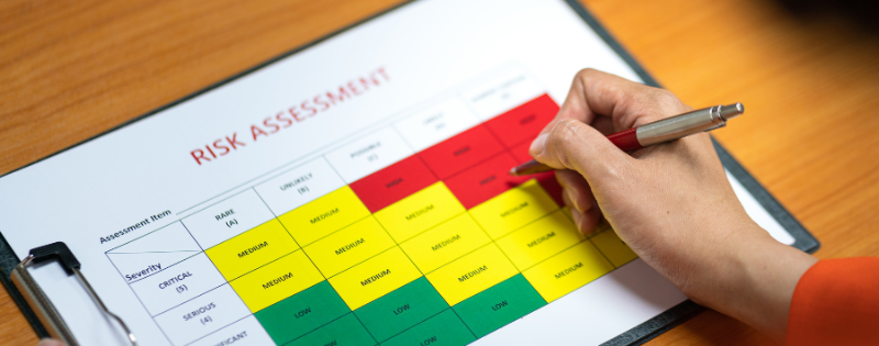 person filling out risk assessment on a clipboard