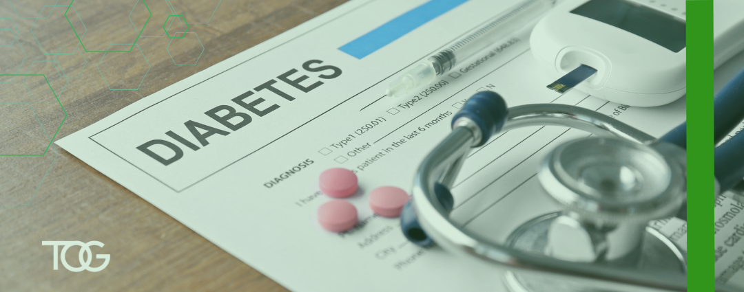 Diabetes medical form with pills and stethoscope placed on top.