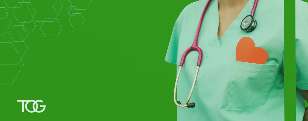 Health care provider with a stethoscope and red paper heart coming out of their pocket to represent American Heart Health Month.